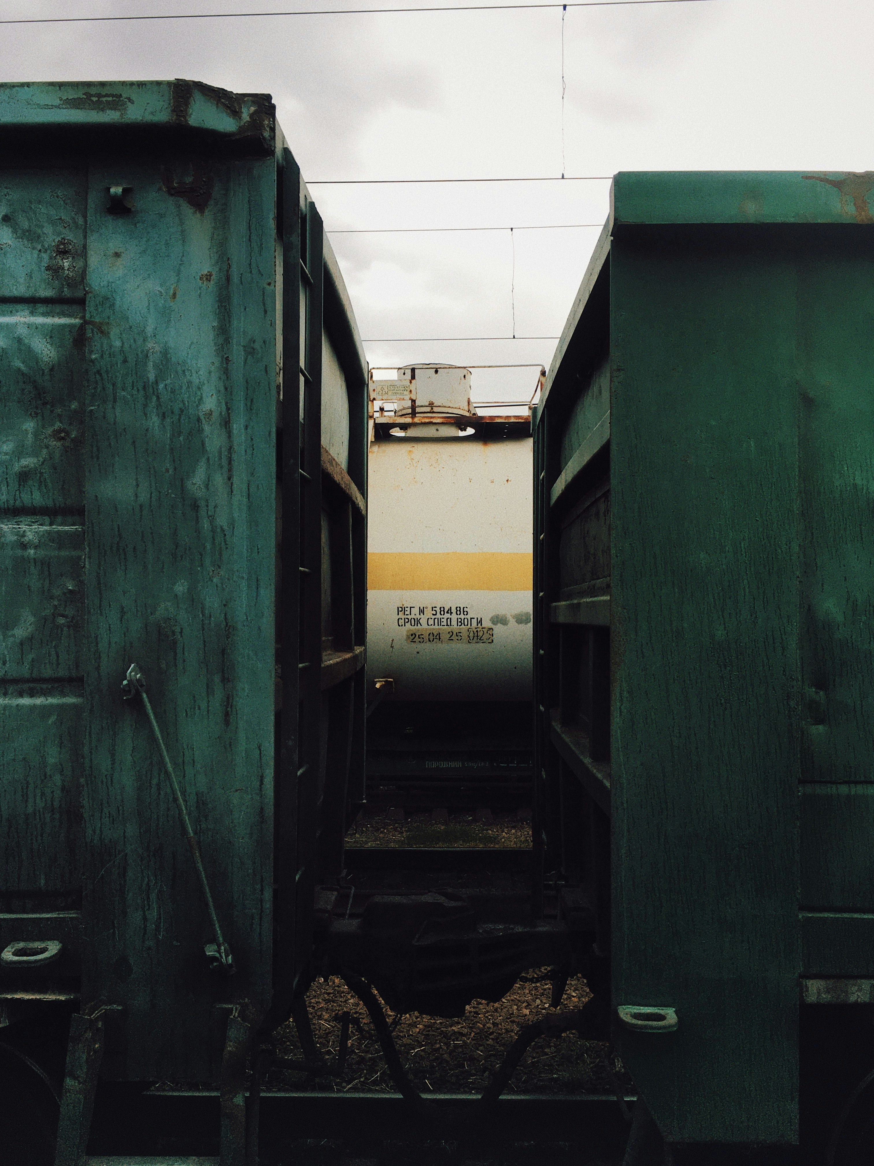 green and yellow train on rail tracks